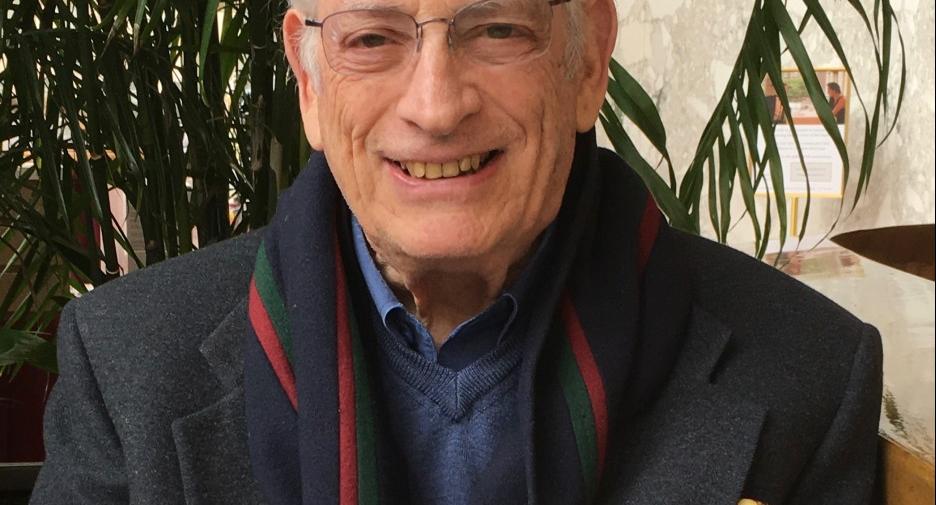 older man in front of a plant